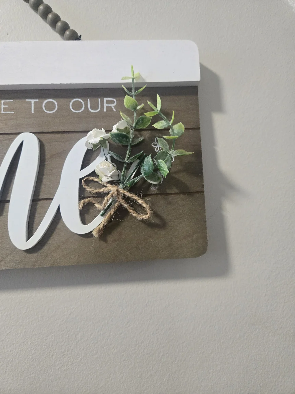 Welcome to Our Home Wooden Wall Sign - White Script on Brown